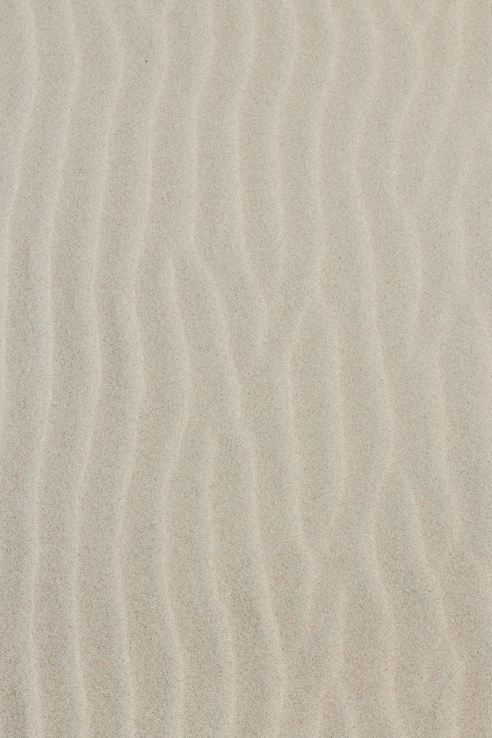 an empty beach with footprints in the sand