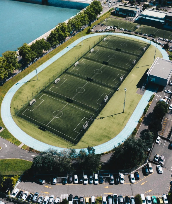 an aerial view of the tennis courts in a parking lot