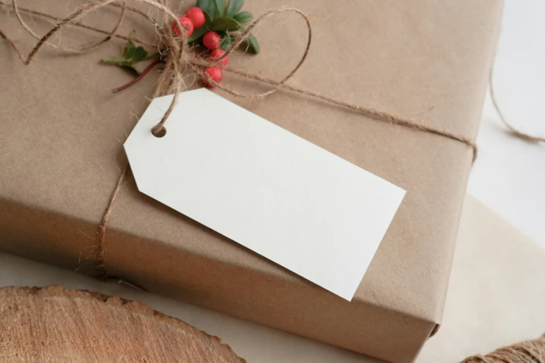 a tag attached to a brown gift box