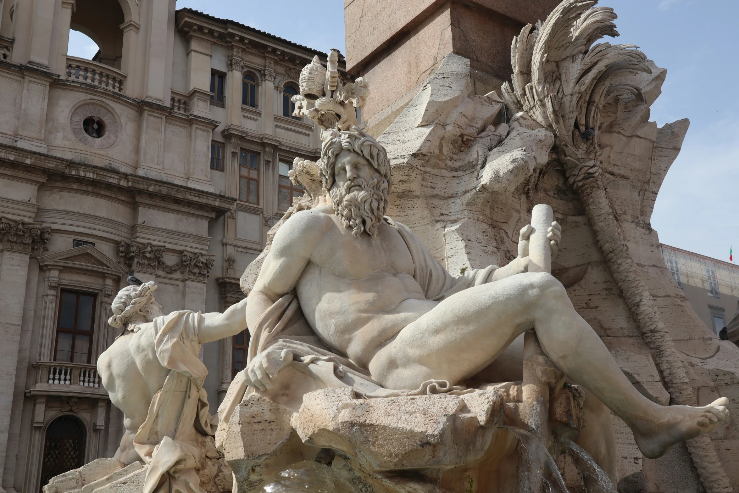 a statue with statues around it is sitting outside