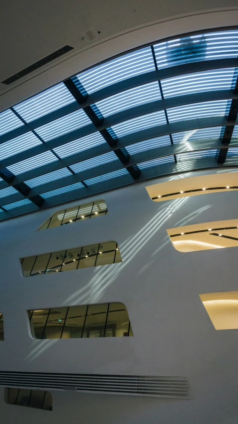 a building with glass windows and lights is shown from above