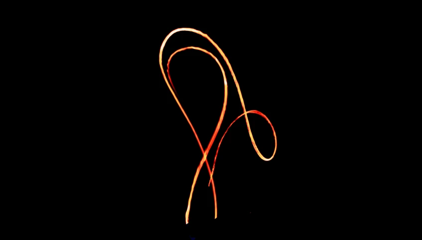 a close - up of an orange string in a dark background
