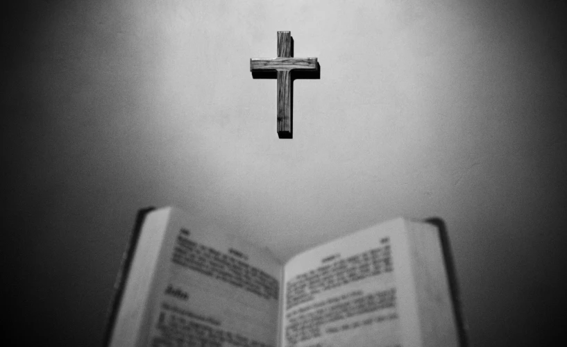 a cross that is sitting on top of a book