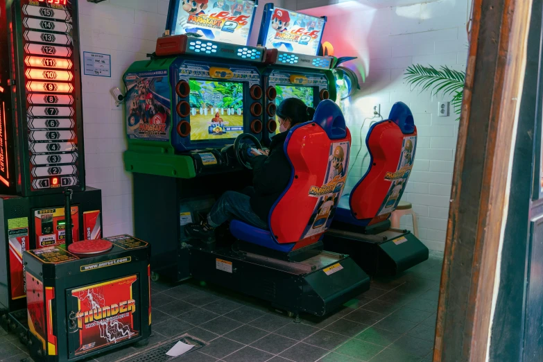 two men playing video games in a museum like setting