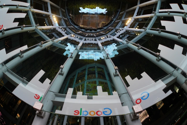 google signage is mounted on the metal pillars and sides of two buildings