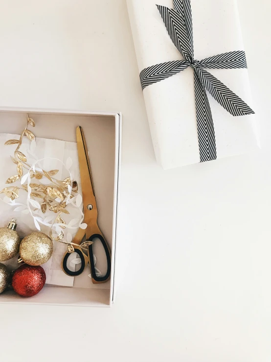 gift wrapping wrapped in black and gold ribbon with scissors