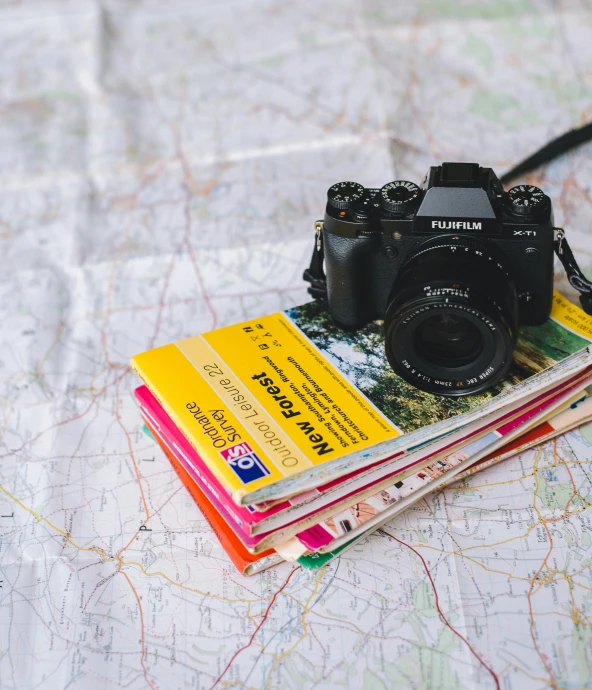 two camera's and some maps on a map