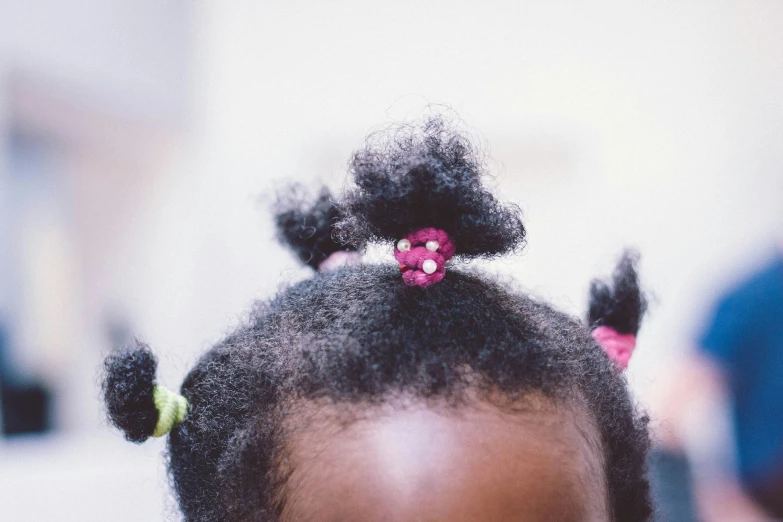 a girl's head wearing an odd hairstyle