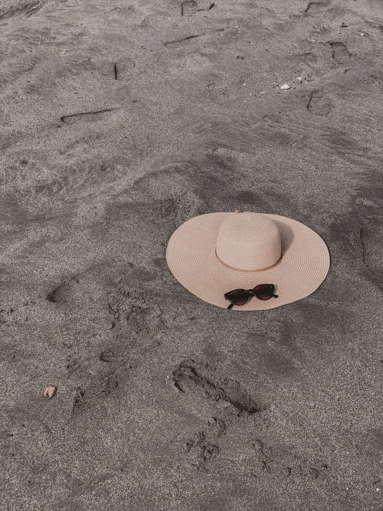 a white hat sitting on top of a dirt field