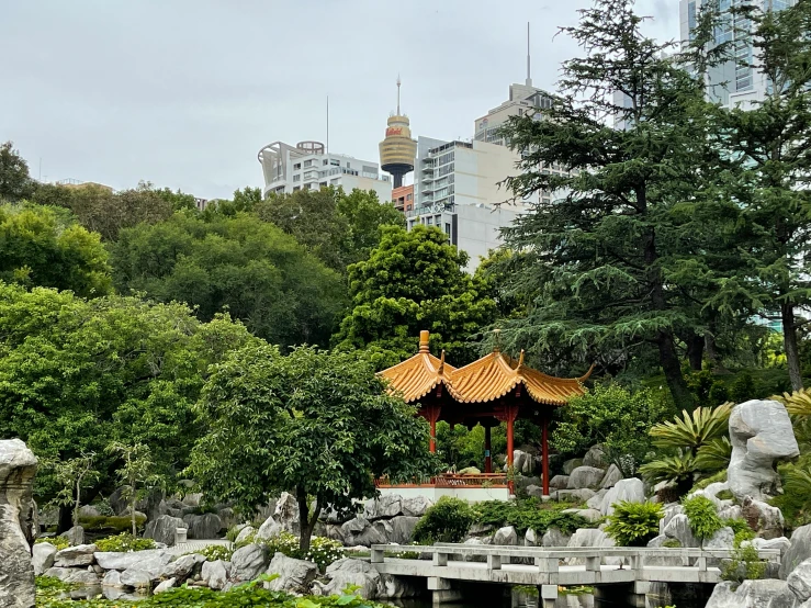 there is a building in the distance behind some rocks