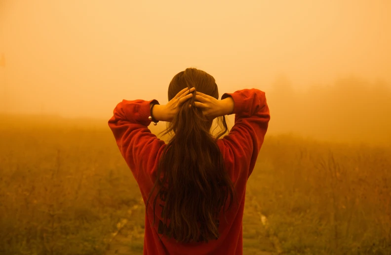 a woman is covering her face from the sun