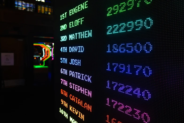 a colorful lit up sign in a dark room
