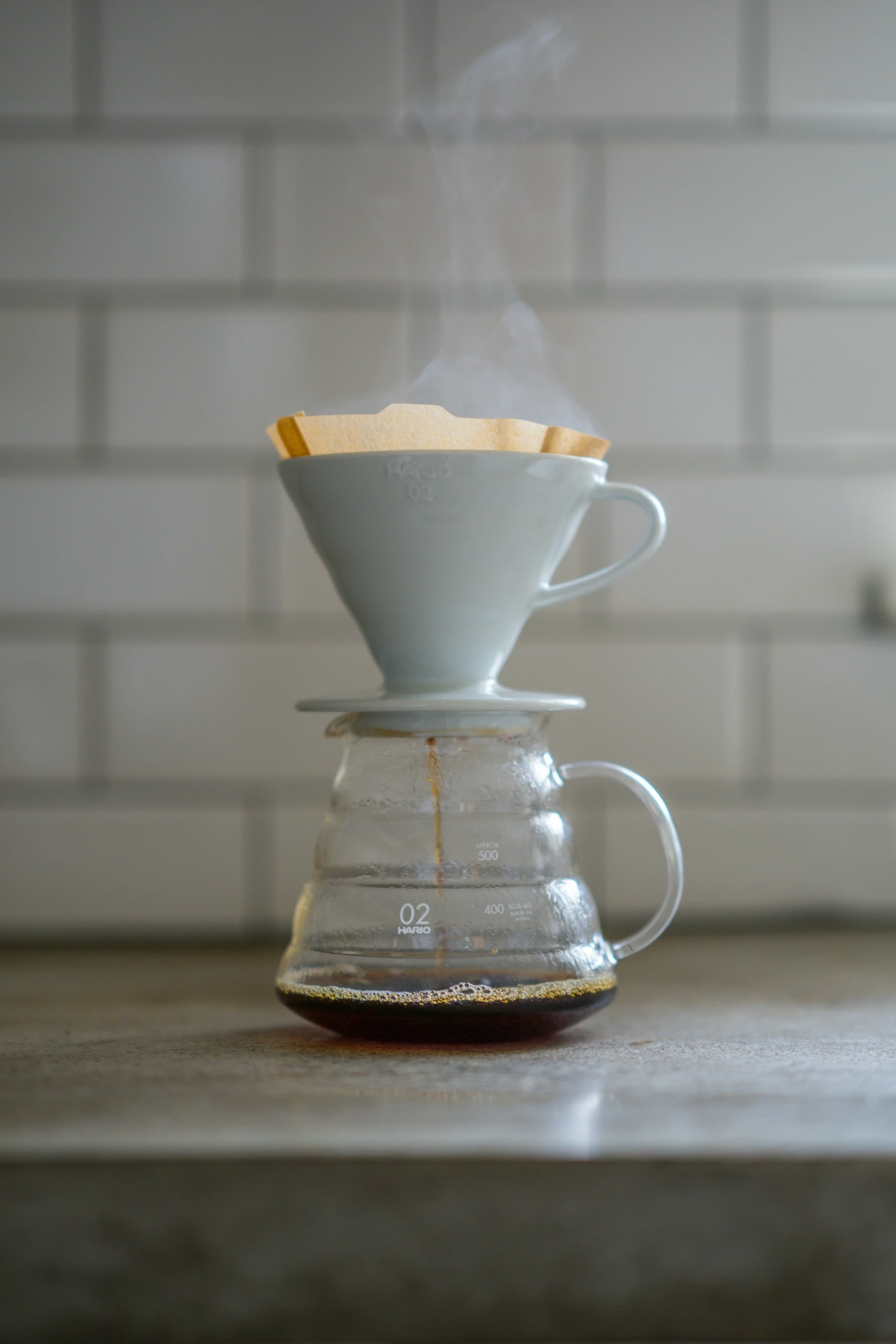 coffee being poured into the cup with  water