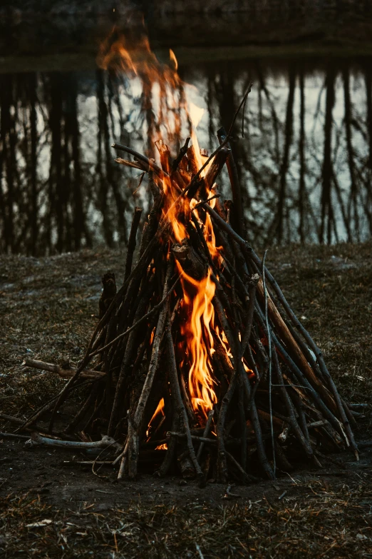 an open fire sitting in the middle of grass