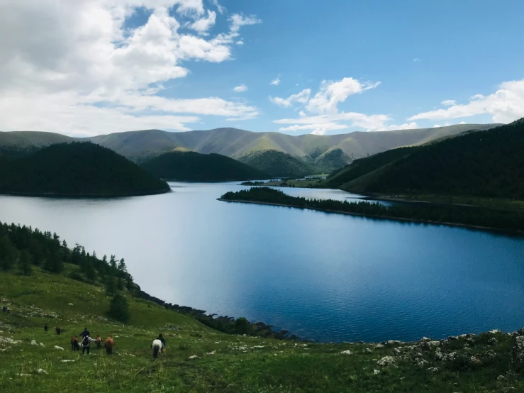 the people are walking around near the lake