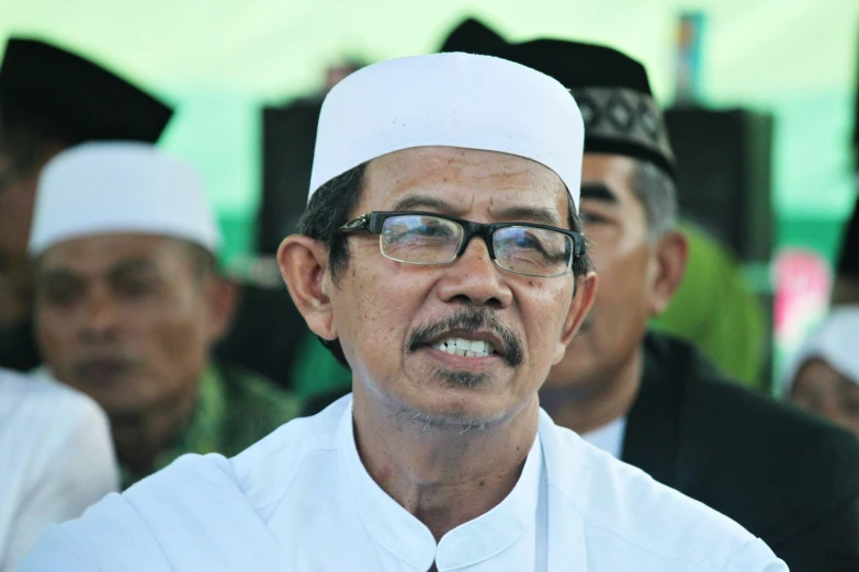 an older muslim man in traditional dress