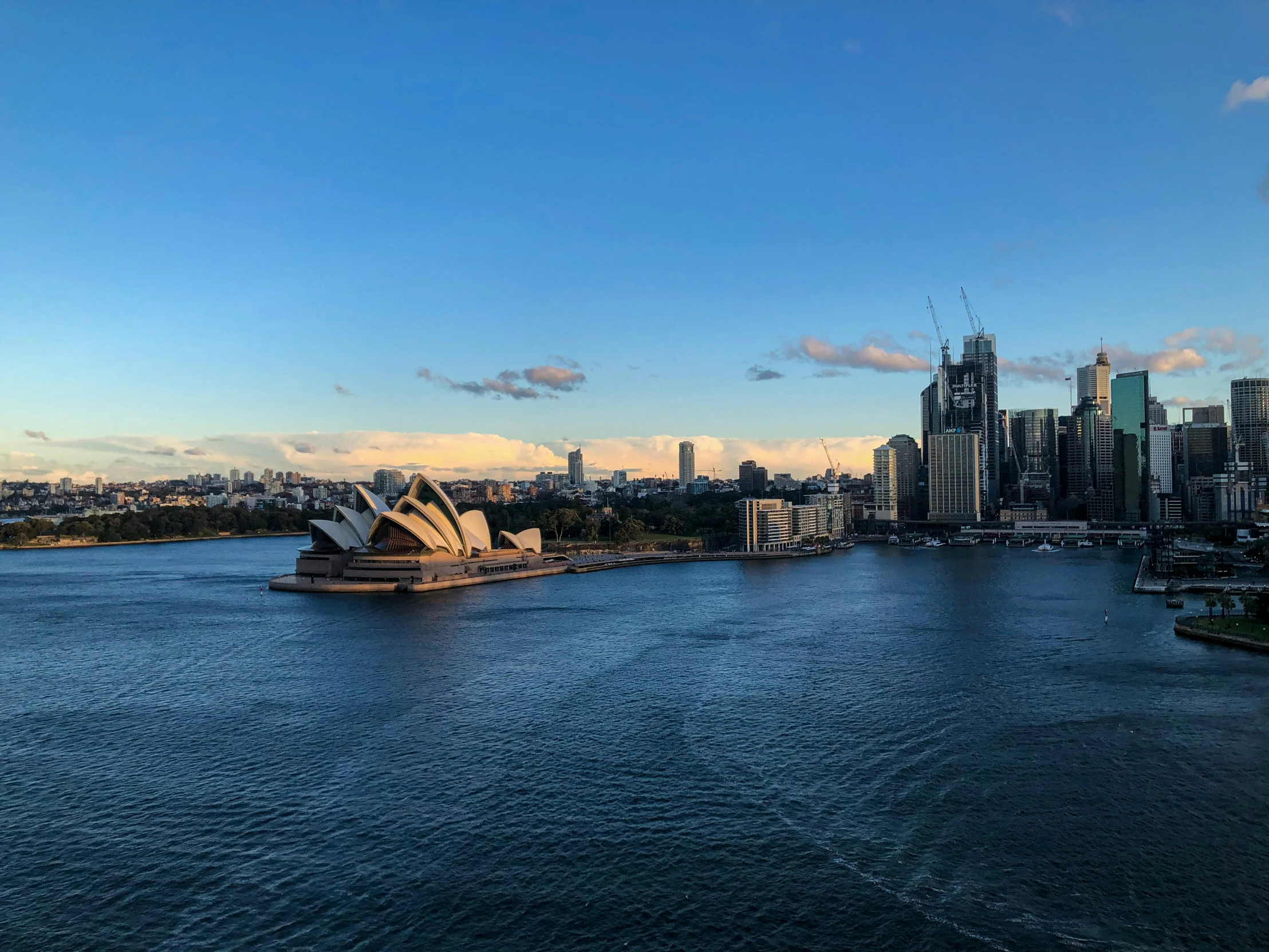 a boat in the water with a city skyline behind it