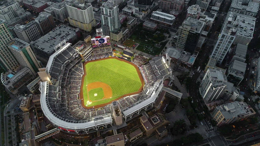 a baseball field is pictured at night from a high view