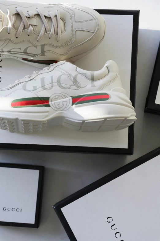 a pair of gucci sneakers on top of a box