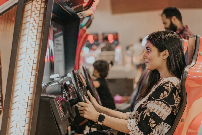 an attractive woman smiles as she plays a video game