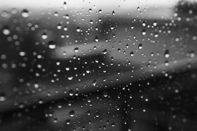 black and white image of raindrops on the glass