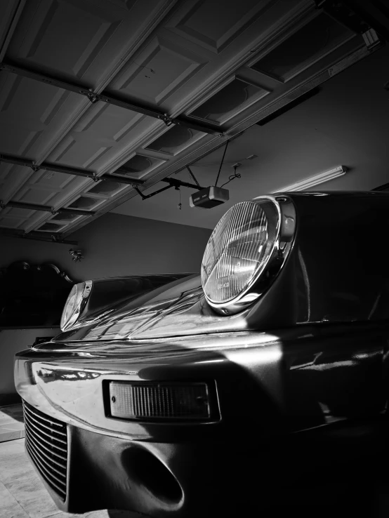 a black and white pograph of two classic car