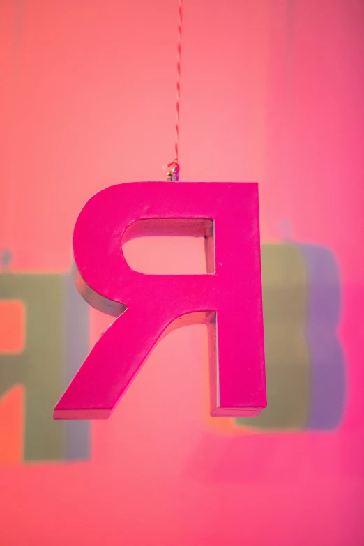 the letter r is hanging on a wall