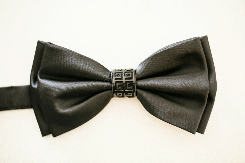 a large black bow with a small metal buckle