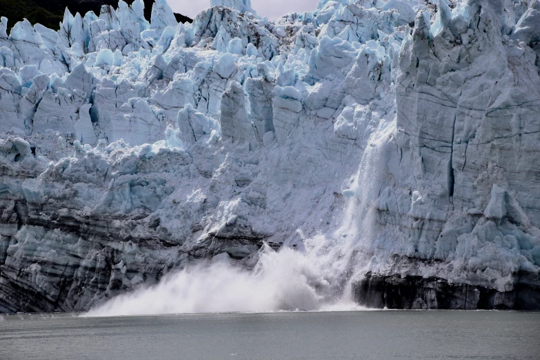 a large waterfall of water near a cliff face