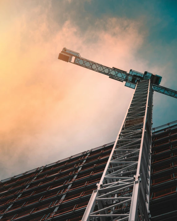 a very tall crane standing near a building