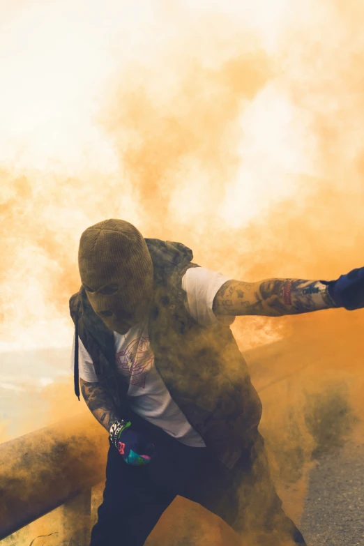 a man standing next to a rail on top of smoke