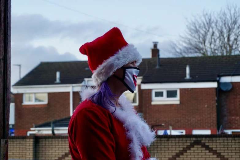 a man in a santa suit talks on his cell phone