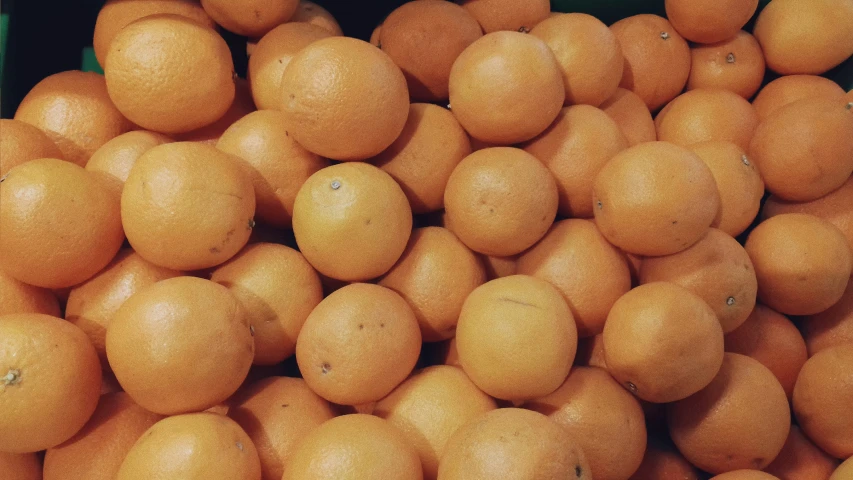 several different kinds of oranges piled on top of each other