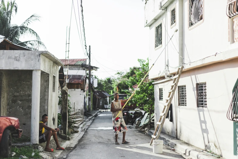 men sitting in the street playing with soing