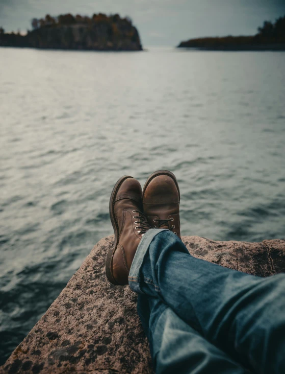 the brown boot is in a man's legs and has one toe up against the wall