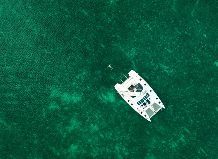 a boat is floating in the sea surrounded by green water