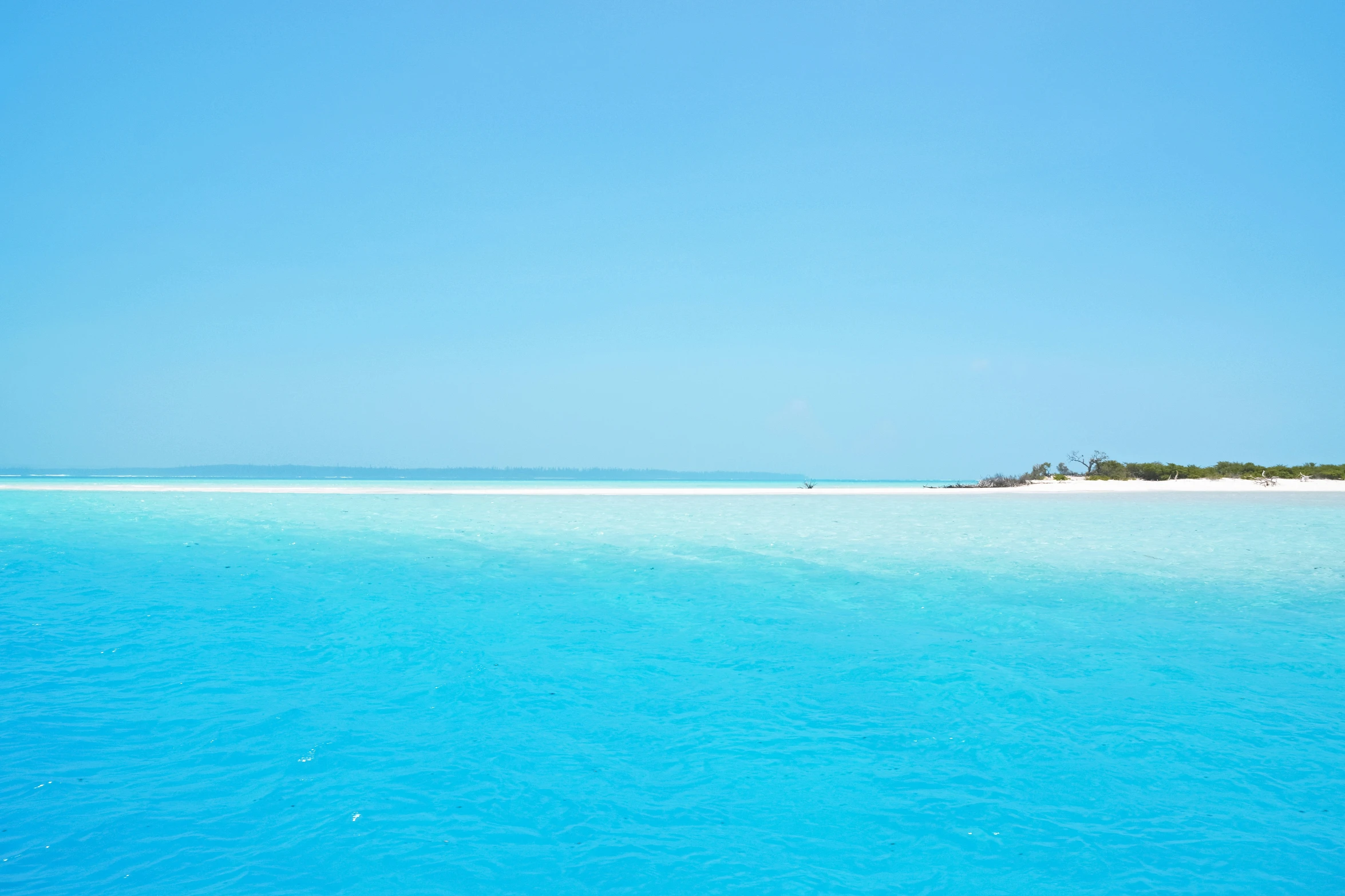 an island in the middle of the ocean near the shore