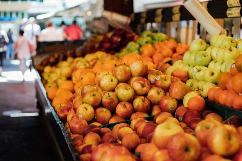 a bunch of fruit are stacked on a table