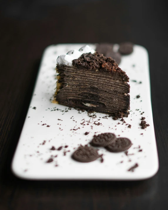 a half eaten chocolate cake and some cookies on top