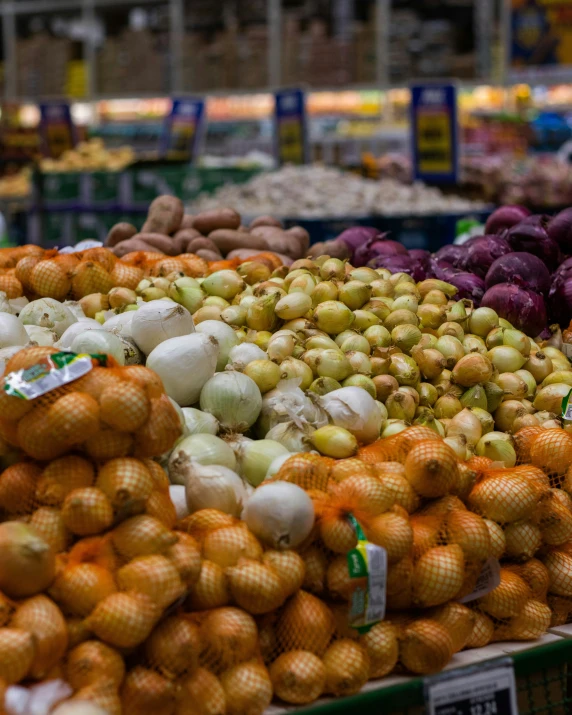 an assortment of fruits and vegetables sitting on display