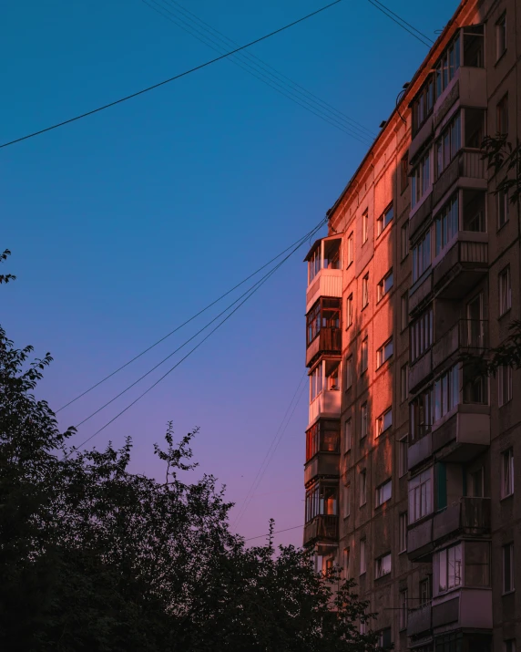 a couple buildings in the middle of a city at dusk