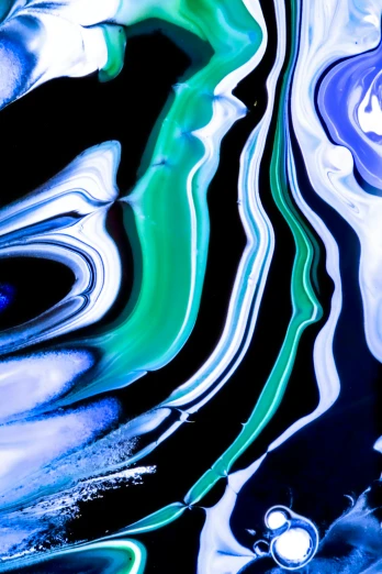 blue and green swirled liquid with streaks of white