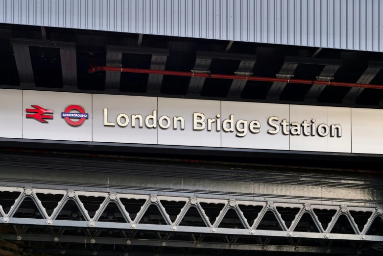 a train station sign with the name london bridge station on it