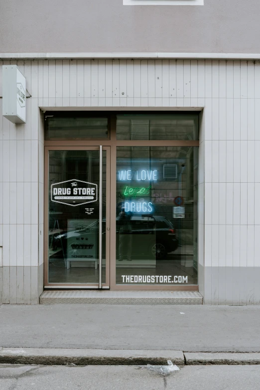 a gray building has a store front and windows