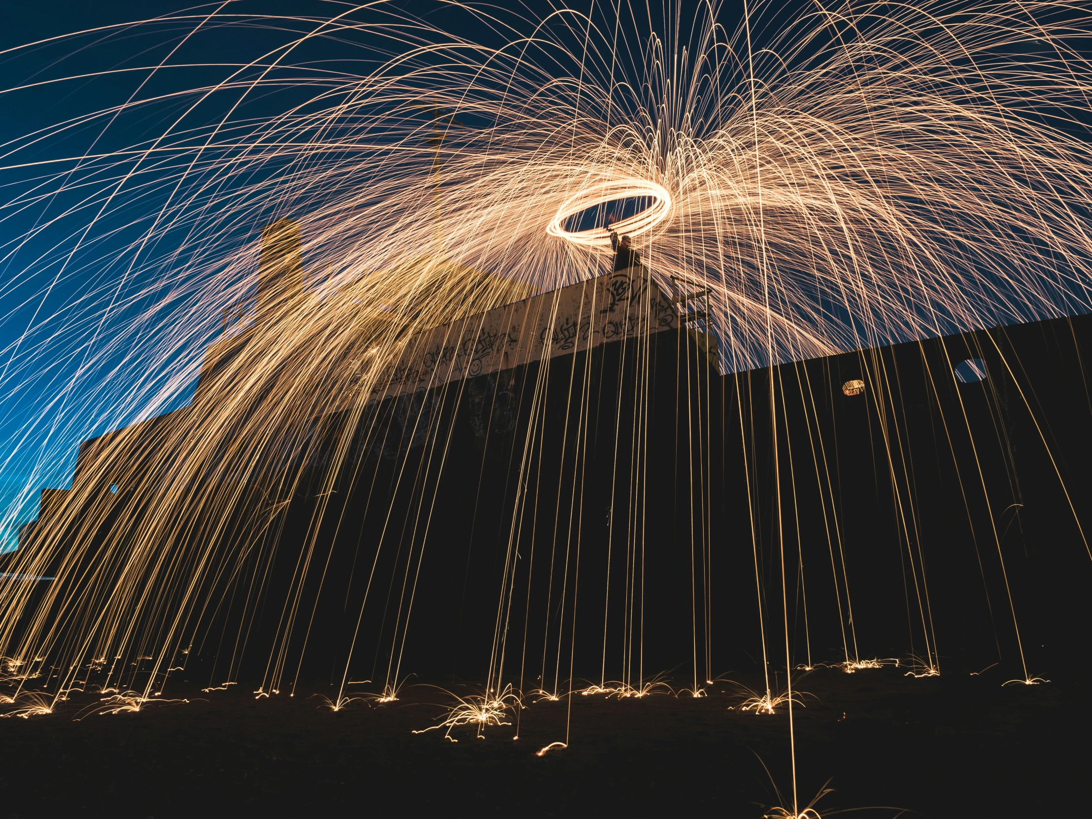 long exposure po showing fireworks against the blue sky