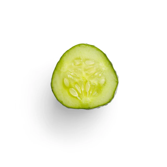 an up close s of a cucumber sliced in half on a white background