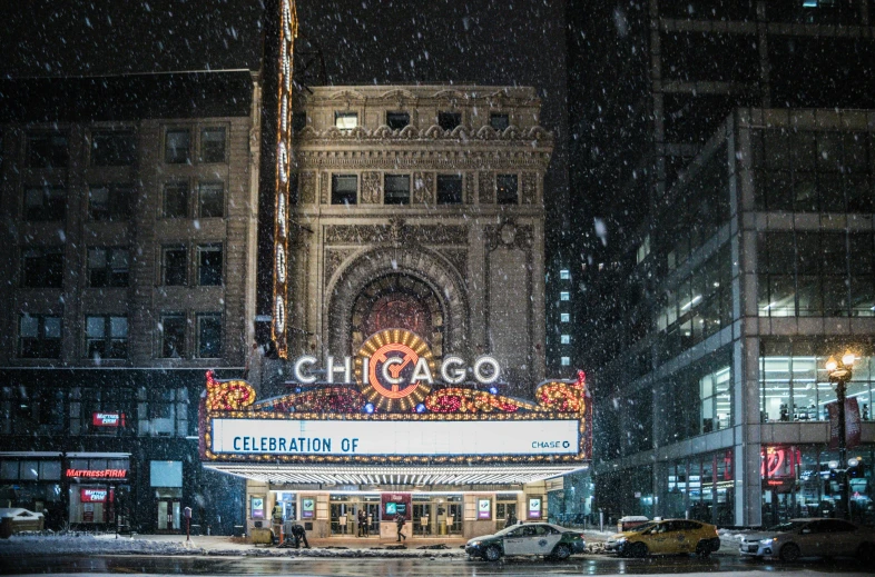 a theatre sign on a building covered in snow