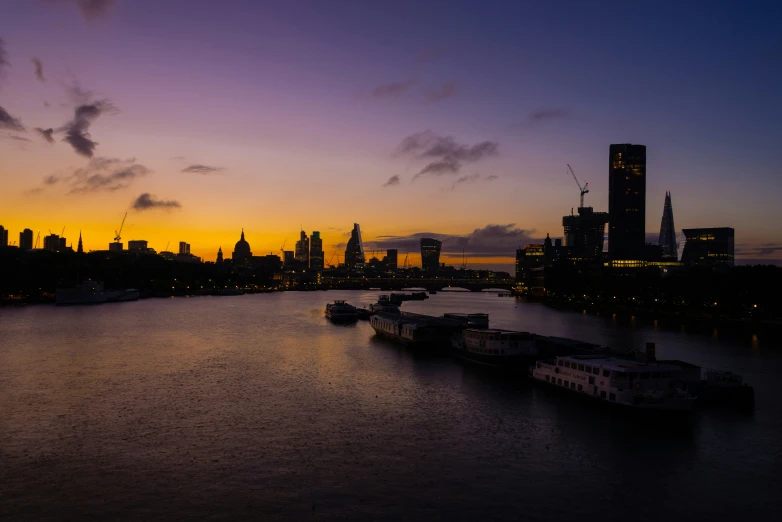 a river that has some boats on it at sunset