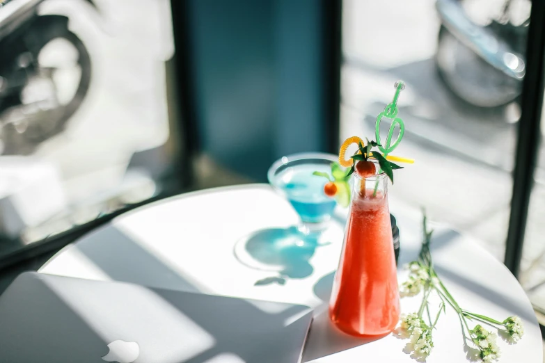 a glass vase with flowers sitting on a table