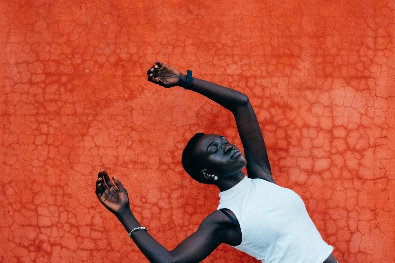 an african american tennis player throws the ball